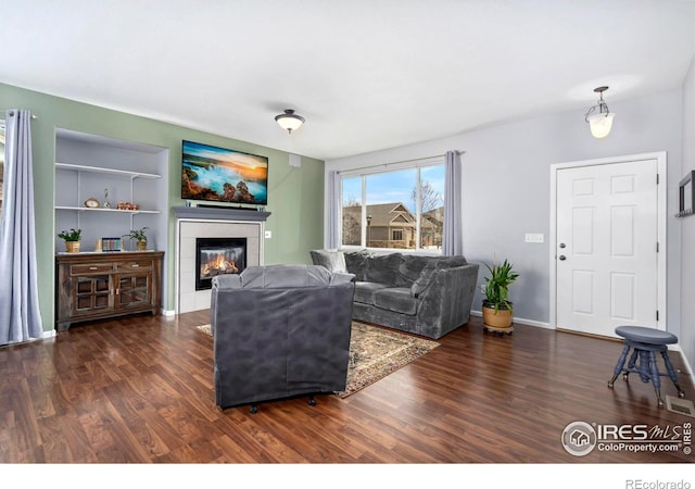 2747 Dafina Dr, Loveland, CO 80537 - living room featuring baseboards, wood finished floors, and a tile fireplace