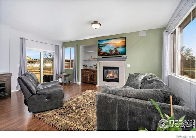 2747 Dafina Dr, Loveland, CO 80537 - living area with a tiled fireplace and wood finished floors