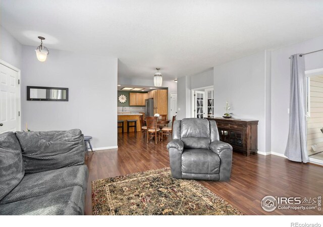2747 Dafina Dr, Loveland, CO 80537 - living area with baseboards, french doors, and dark wood finished floors