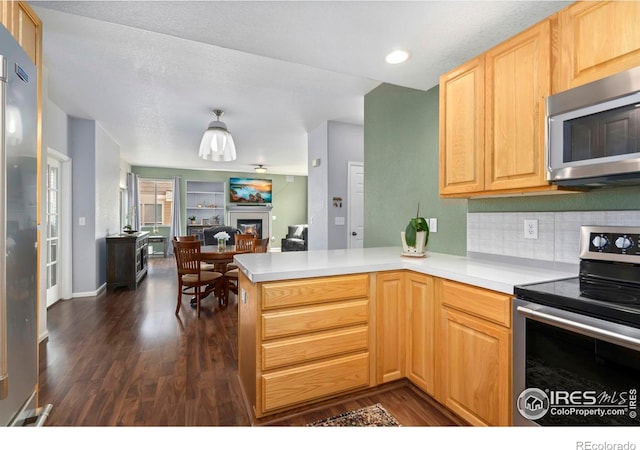 2747 Dafina Dr, Loveland, CO 80537 - kitchen featuring a peninsula, light brown cabinets, open floor plan, dark wood-style floors, and appliances with stainless steel finishes