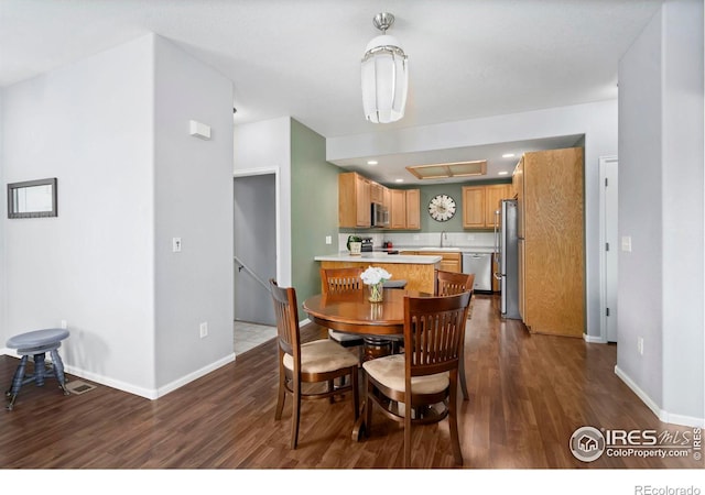 2747 Dafina Dr, Loveland, CO 80537 - dining room with baseboards, recessed lighting, and dark wood finished floors