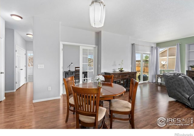 2747 Dafina Dr, Loveland, CO 80537 - dining area featuring baseboards, a textured ceiling, and wood finished floors