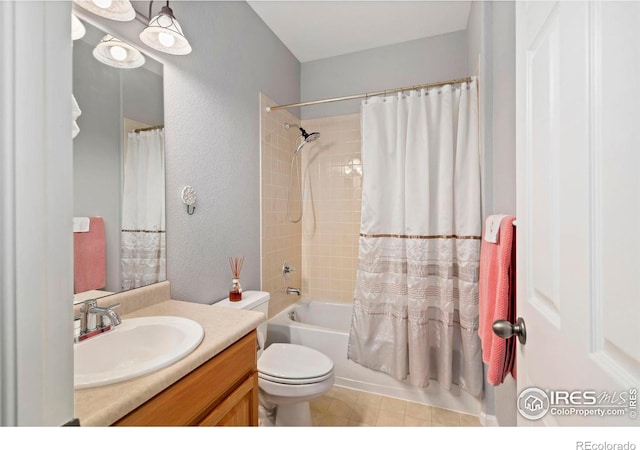 2747 Dafina Dr, Loveland, CO 80537 - full bathroom featuring vanity, a textured wall, shower / bath combo with shower curtain, and toilet