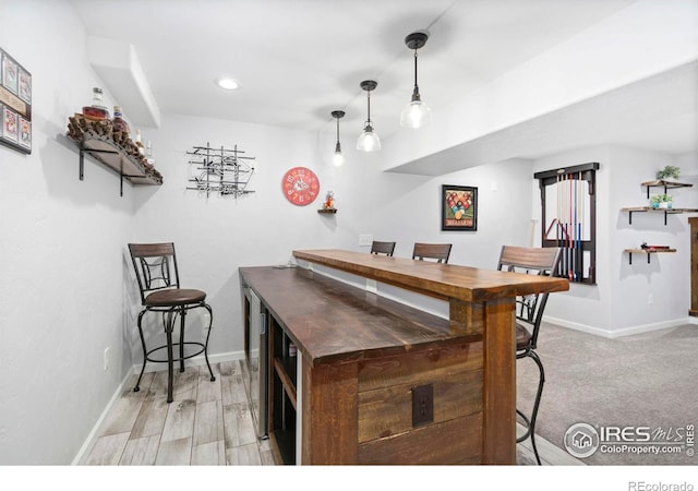 2747 Dafina Dr, Loveland, CO 80537 - bar featuring pendant lighting, baseboards, and recessed lighting