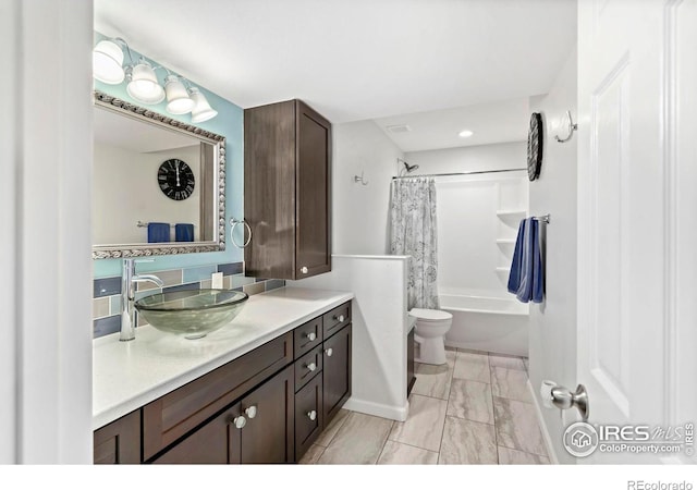 2747 Dafina Dr, Loveland, CO 80537 - full bath with vanity, shower / bath combo with shower curtain, marble finish floor, toilet, and recessed lighting