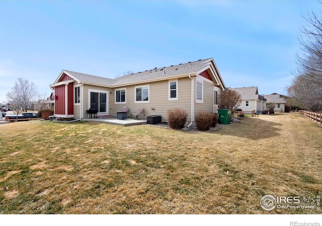2747 Dafina Dr, Loveland, CO 80537 - back of house featuring a lawn, a patio, and board and batten siding