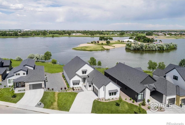 drone / aerial view featuring a water view and a residential view