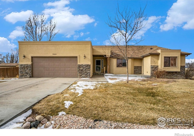 7889 Antelope Ct, Wellington, CO 80549 - view of front facade with stucco siding, an attached garage, stone siding, and concrete driveway