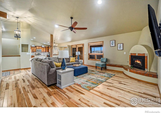 7889 Antelope Ct, Wellington, CO 80549 - living area featuring a ceiling fan, a fireplace, lofted ceiling, light wood-style flooring, and baseboards