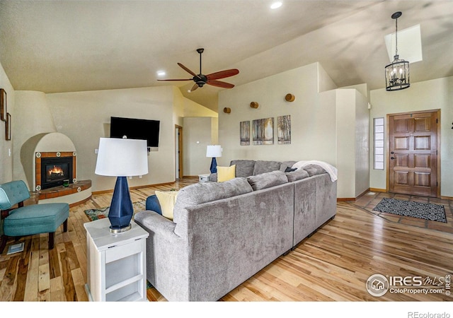 7889 Antelope Ct, Wellington, CO 80549 - living area featuring baseboards, light wood-style flooring, ceiling fan, and a glass covered fireplace