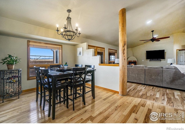 7889 Antelope Ct, Wellington, CO 80549 - dining room with light wood-style flooring, ceiling fan with notable chandelier, baseboards, and vaulted ceiling