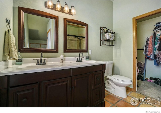 7889 Antelope Ct, Wellington, CO 80549 - full bath featuring double vanity, a sink, toilet, and tile patterned floors