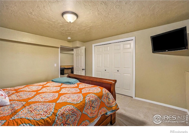 7889 Antelope Ct, Wellington, CO 80549 - carpeted bedroom featuring a closet, a textured ceiling, and baseboards
