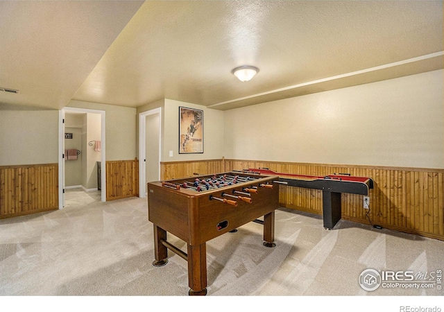 7889 Antelope Ct, Wellington, CO 80549 - rec room with wood walls, carpet, a textured ceiling, and wainscoting