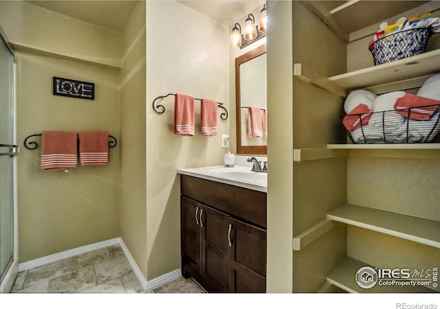 7889 Antelope Ct, Wellington, CO 80549 - bathroom featuring baseboards and vanity