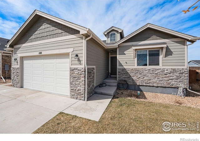 1108 Osprey Way, Wiggins, CO 80654 - view of front of house featuring stone siding, an attached garage, and driveway