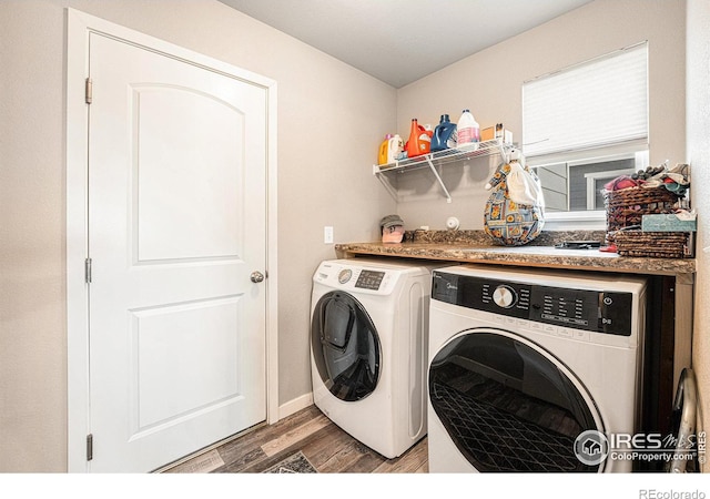 1108 Osprey Way, Wiggins, CO 80654 - laundry area with washing machine and dryer, baseboards, laundry area, and light wood-type flooring