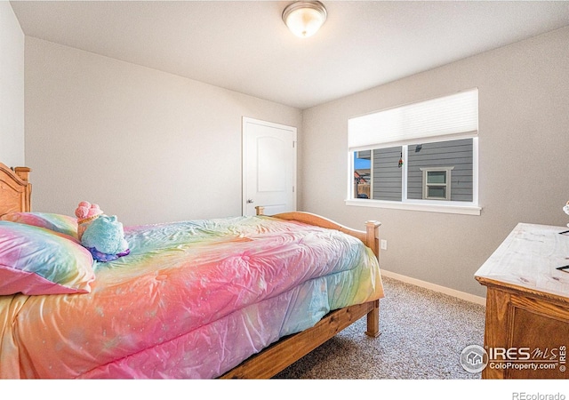 1108 Osprey Way, Wiggins, CO 80654 - bedroom with baseboards and carpet flooring