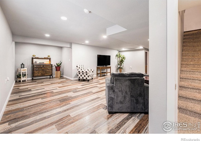 1108 Osprey Way, Wiggins, CO 80654 - living room with baseboards, recessed lighting, wood finished floors, and stairway