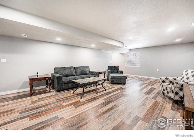 1108 Osprey Way, Wiggins, CO 80654 - living room featuring baseboards, visible vents, a textured ceiling, and wood finished floors