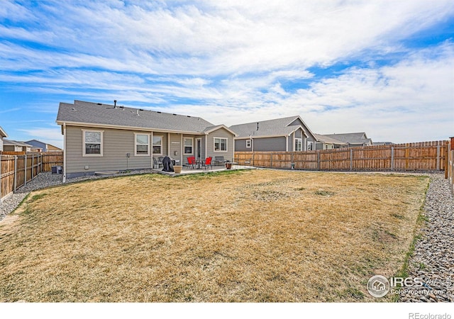 1108 Osprey Way, Wiggins, CO 80654 - back of property featuring a lawn, a fenced backyard, and a patio area