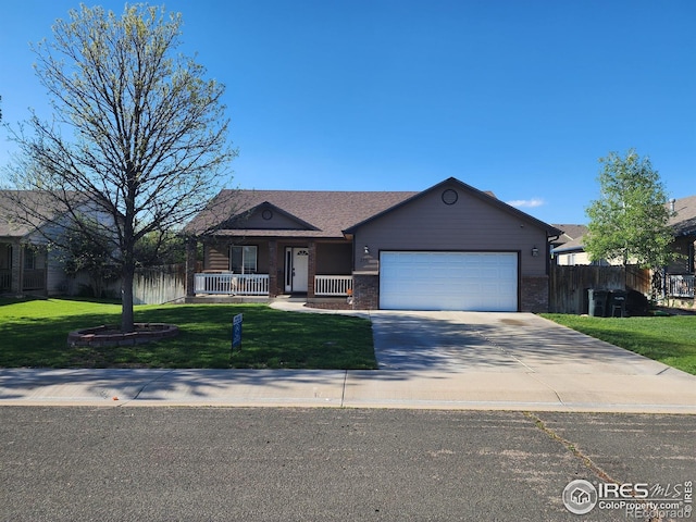 273 S 5th St, Way, La Salle, CO 80645 - ranch-style house featuring an attached garage, concrete driveway, and covered porch