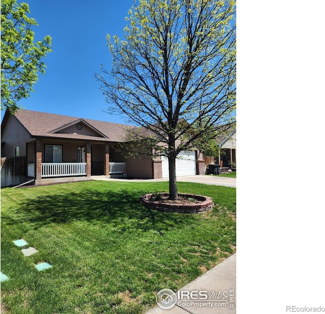 273 S 5th St, Way, La Salle, CO 80645 - view of front of home with brick siding, driveway, a porch, a garage, and a front lawn