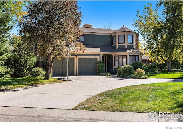 6850 Frying Pan Rd, Boulder, CO 80301 - view of front of home with driveway, a front lawn, an attached garage, and roof with shingles