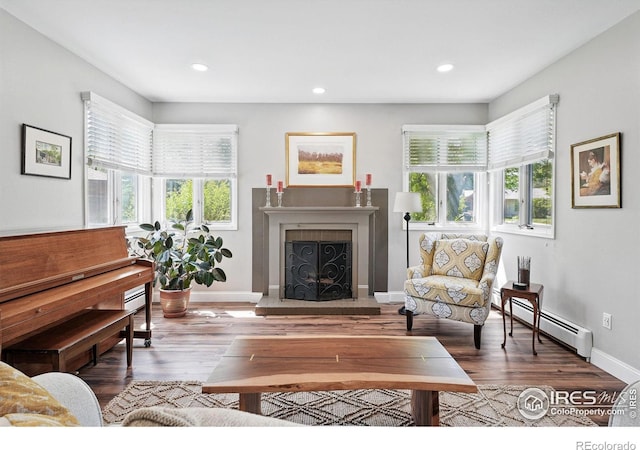 6850 Frying Pan Rd, Boulder, CO 80301 - living room with a baseboard radiator, a fireplace with raised hearth, wood finished floors, baseboards, and recessed lighting