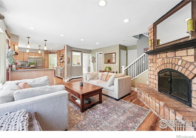 6850 Frying Pan Rd, Boulder, CO 80301 - living room with a baseboard radiator, light wood-style floors, recessed lighting, a brick fireplace, and baseboards