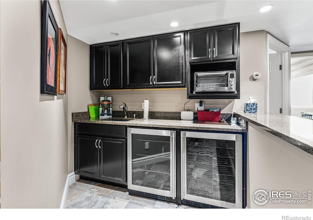 6850 Frying Pan Rd, Boulder, CO 80301 - indoor wet bar featuring beverage cooler, baseboards, and recessed lighting