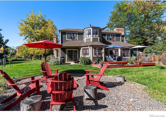 6850 Frying Pan Rd, Boulder, CO 80301 - rear view of property featuring a fire pit, a yard, a chimney, and a deck