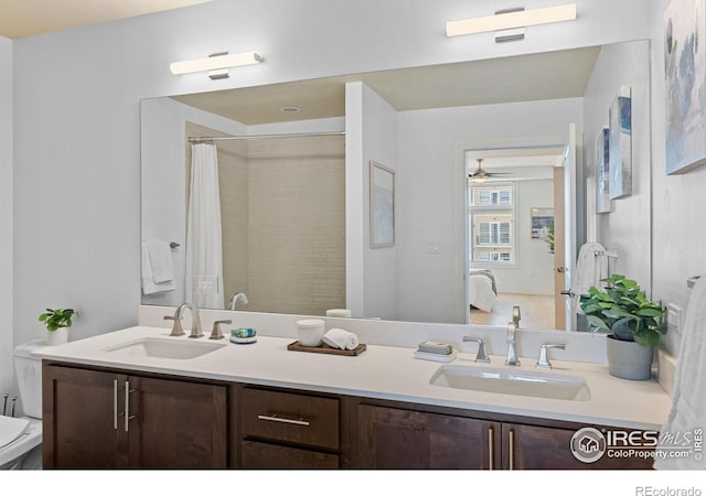 full bathroom featuring toilet, double vanity, and a shower with shower curtain