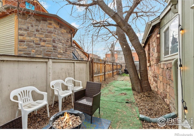 view of yard with an outdoor fire pit and a fenced backyard