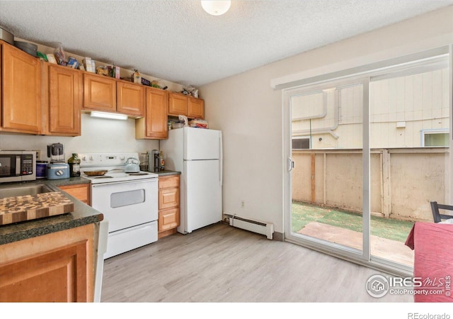 kitchen with white appliances, a textured ceiling, dark countertops, light wood finished floors, and baseboard heating