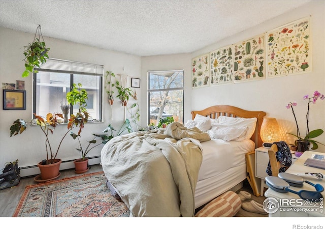 bedroom featuring a textured ceiling and wood finished floors