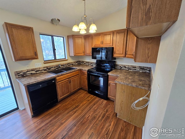 609 Andrea St, Fort Collins, CO 80524 - kitchen with black appliances, a sink, dark wood finished floors, dark countertops, and a chandelier