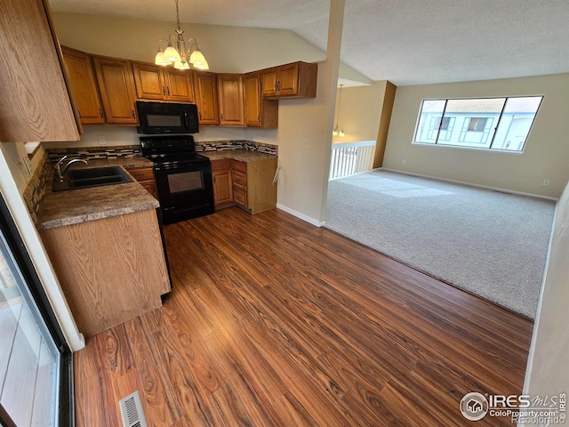 609 Andrea St, Fort Collins, CO 80524 - kitchen featuring black appliances, a sink, brown cabinets, lofted ceiling, and baseboards
