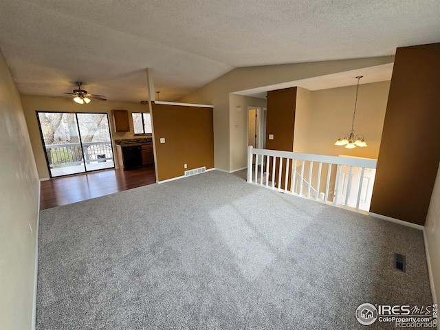 609 Andrea St, Fort Collins, CO 80524 - unfurnished living room with dark colored carpet, a chandelier, lofted ceiling, ceiling fan, and baseboards