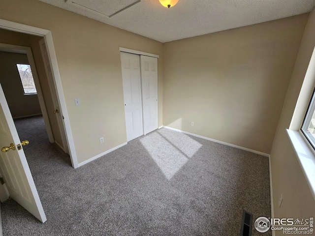 609 Andrea St, Fort Collins, CO 80524 - unfurnished bedroom with carpet, baseboards, a closet, and a textured ceiling