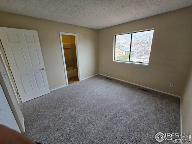 609 Andrea St, Fort Collins, CO 80524 - unfurnished bedroom featuring carpet flooring, baseboards, a textured ceiling, and ensuite bathroom