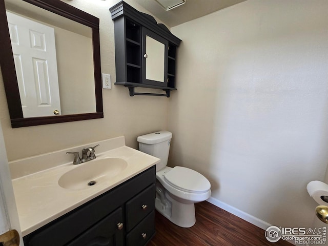 609 Andrea St, Fort Collins, CO 80524 - bathroom featuring wood finished floors, baseboards, toilet, and vanity