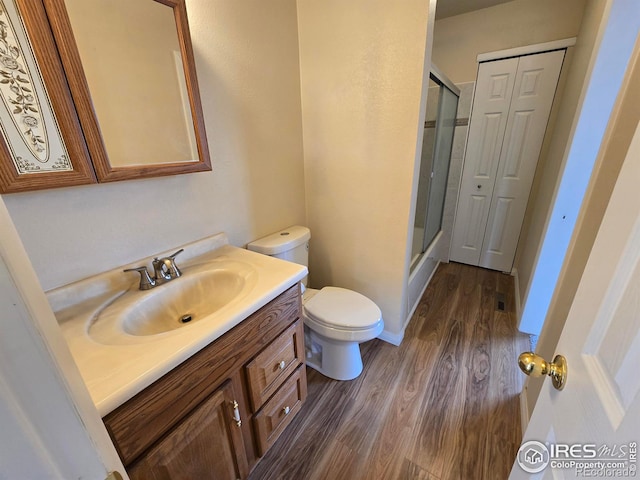 609 Andrea St, Fort Collins, CO 80524 - bathroom featuring wood finished floors, a stall shower, vanity, and toilet
