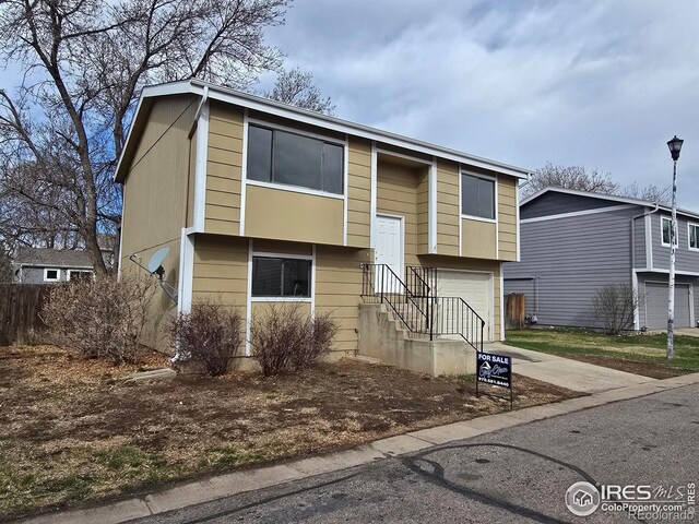 609 Andrea St, Fort Collins, CO 80524 - raised ranch with an attached garage and concrete driveway