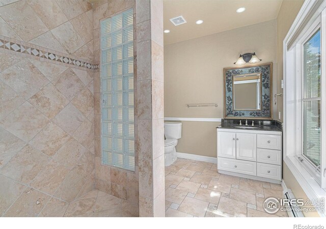 2625 Marys Lake Rd Unit S2, Estes Park, CO 80517 - bathroom with vanity, a tile shower, toilet, baseboards, and visible vents
