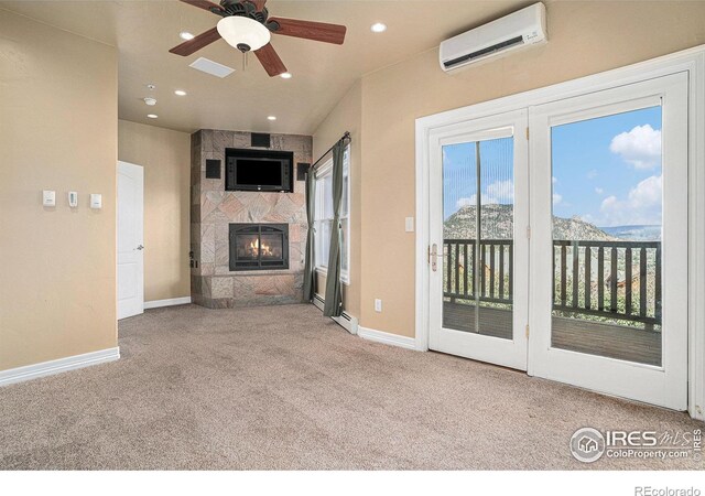 2625 Marys Lake Rd Unit S2, Estes Park, CO 80517 - unfurnished living room with a wealth of natural light, a fireplace, a wall mounted air conditioner, and carpet
