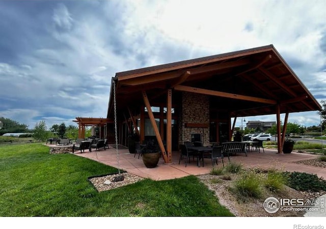 2449 Trio Falls Dr, Loveland, CO 80538 - view of community featuring a lawn, a patio, and a pergola