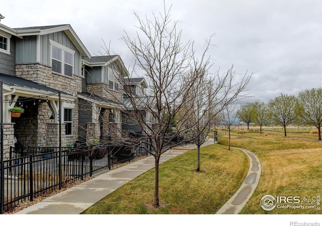 2449 Trio Falls Dr, Loveland, CO 80538 - surrounding community with a lawn and fence
