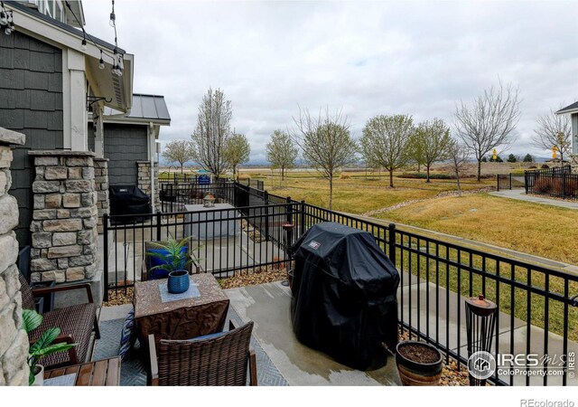 2449 Trio Falls Dr, Loveland, CO 80538 - view of patio featuring fence and a grill