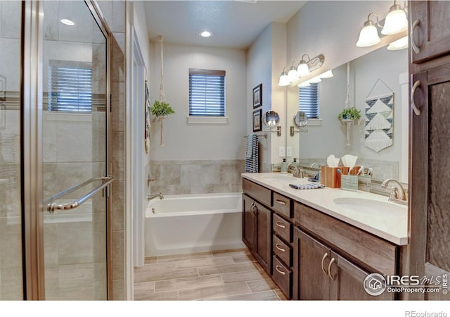 2449 Trio Falls Dr, Loveland, CO 80538 - bathroom featuring double vanity, a shower stall, a sink, and a bath